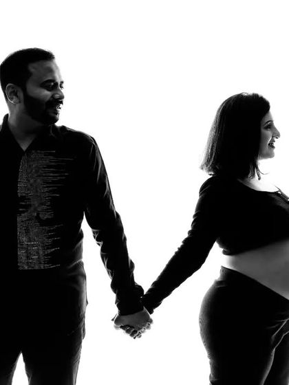 In black and white, this silhouette portrait becomes even more striking. The clean lines and contrast draw all the attention to the couple's connection and the beautiful shape of the baby bump.
