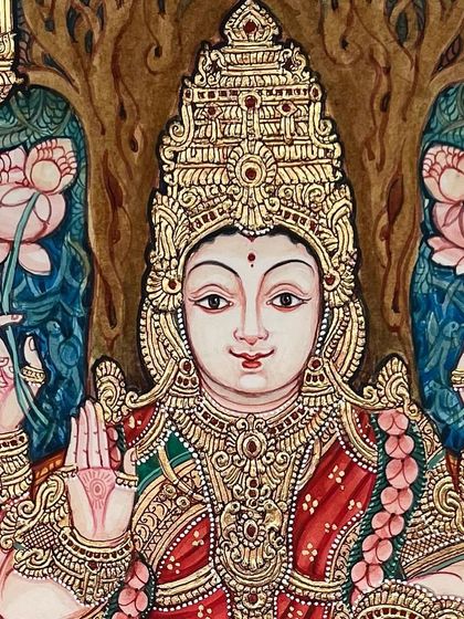 Another beautiful close-up of a Goddess Lakshmi painting, highlighting the delicate features and the richness of the gold work on her crown and jewelry.