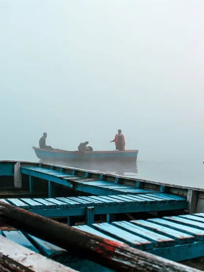 I took this shot from inside one boat, looking out towards another. This perspective gives a sense of being right there on the water, part of the quiet morning ritual.