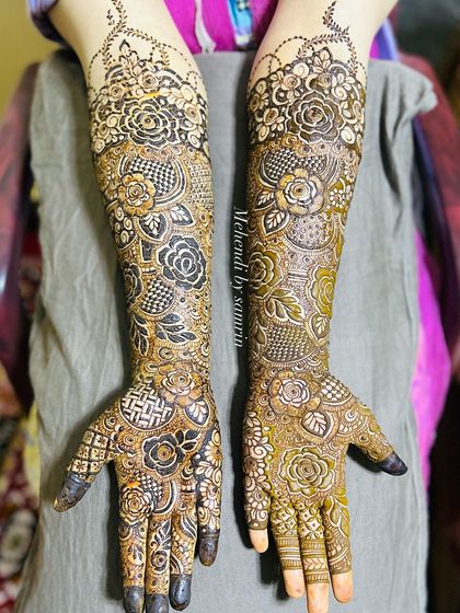 Another view of Roohi's bridal mehendi. The floral patterns are bold and beautiful, covering the hands and arms completely.