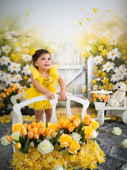 Standing on a little white bridge in her sunshine-yellow garden.