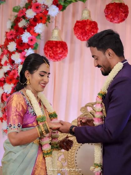 Another angle of the ring exchange, capturing the couple's happy expressions as they complete the ritual.