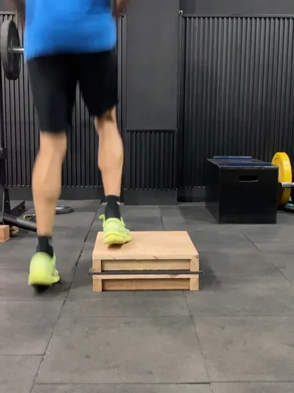An athlete performing a step-off jump, a drill that teaches proper landing mechanics and force absorption.