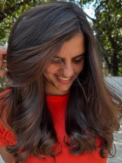 A simple highlight refresh can make a world of difference. I brightened up her existing color and gave her a fresh style, making her hair look vibrant and healthy again.