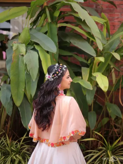 Another view of the beautiful floral headpiece and soft waves. This hairstyle is perfect for a bride who wants a unique and nature-inspired look for her pre-wedding events.