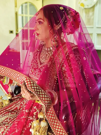 A timeless portrait of one of my brides. I focused on creating a classic red bridal look with defined eyes and a radiant base, complemented by a beautiful hair bun and traditional jewellery.