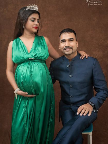 A regal portrait of the expecting couple. Adding a tiara can make the mom-to-be feel like royalty, and the partner's proud look completes the picture.