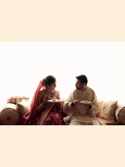 Even sharing a meal can be a beautiful, intimate moment on a wedding day. This wide shot captures the couple in a quiet, everyday act of love, a reminder that marriage is built on these simple, shared experiences.