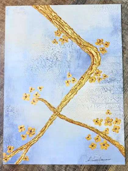 This sample board showcases a textured background with sculpted branches and small flowers, finished with gold leaf. It's a perfect example of how I test the interplay of color, texture, and metallic finishes for a luxurious effect.
