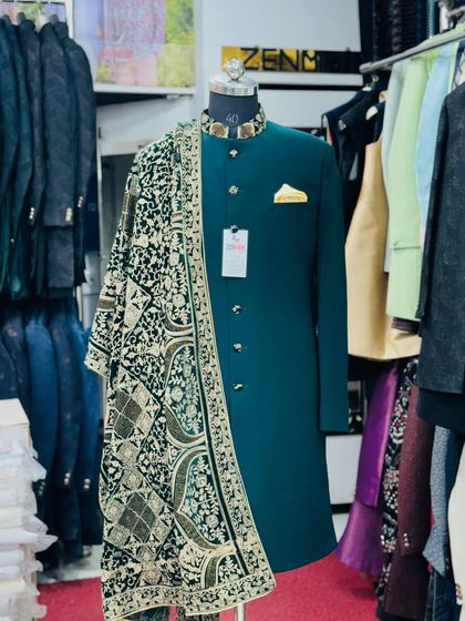 A full look at the emerald green sherwani, showcasing the beautiful drape of the embroidered velvet dupatta. This is a perfect choice for a Mehendi or Sangeet ceremony.