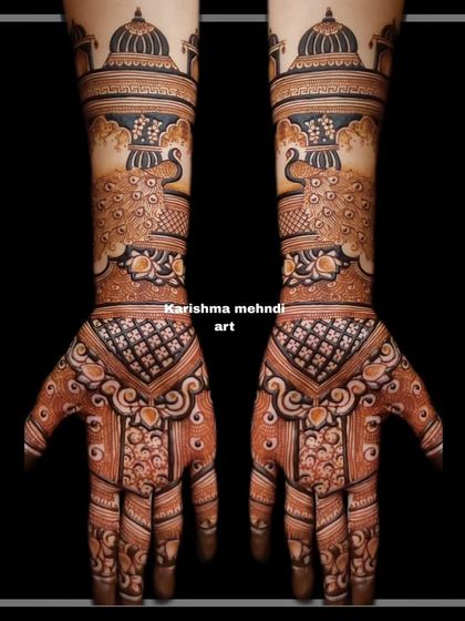 This design features prominent peacock figures beneath architectural domes, creating a regal and symmetrical look. The palms are filled with intricate patterns that complement the main motifs on the arms.