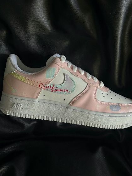 A new edition of the Taylor Swift custom Nike Air Force 1s, inspired by the "Lover" album with pastel pinks and "Cruel Summer" text.