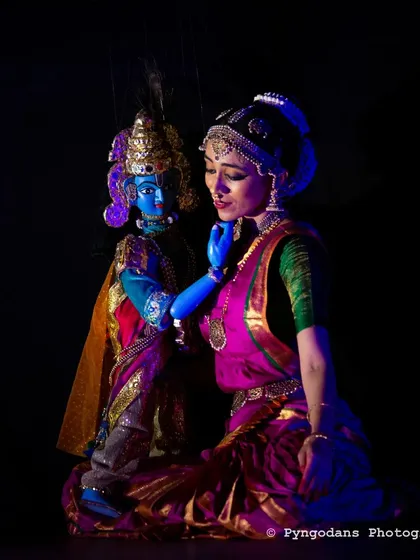 This is a moment from 'Sutradhari Vaidarbhi', a piece where I bring together two art forms I grew up with: Bharatanatyam and Bombeyaata, or string puppetry. Here, as Rukmini, I share the stage with Krishna, brought to life by the strings. This fusion of dance and puppetry is a special service I offer for a truly unique performance.