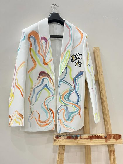 Another view of the abstract, colorful-lined blazer. The lines flow and curve around the jacket, creating a sense of movement and energy.