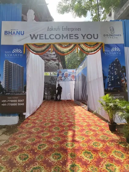 A great event starts with a great entrance. I design and build welcome gates like this one for a corporate real estate event, complete with branding, floral garlands, and a red carpet walkway.