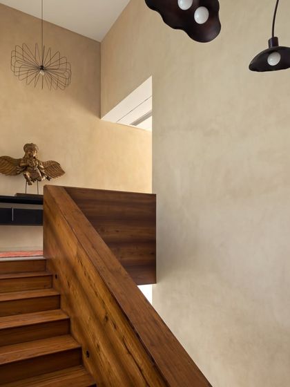 Another view of the staircase at the House of Terraces, highlighting the beautiful grain of the recycled teak wood and the sculptural quality of its construction.