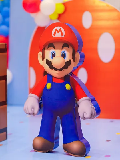 A life-sized Super Mario character prop stands ready to welcome guests. The high-quality cutout adds a professional and immersive touch to the video game-themed celebration.