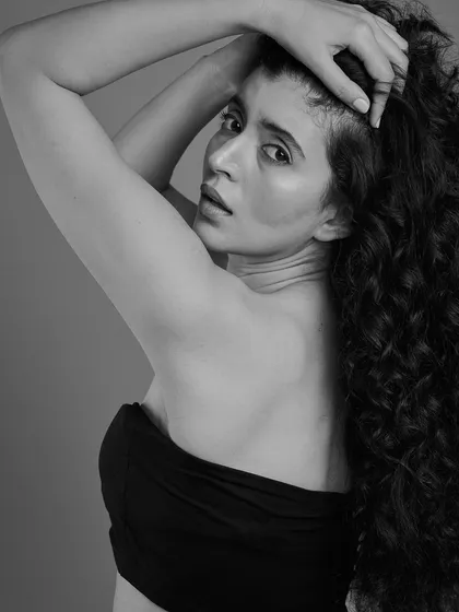 A more introspective pose from the same series. The black and white treatment adds a timeless, artistic quality to the portrait.