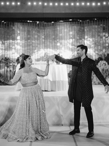 A black and white photo of the couple's dance performance, capturing the movement and joy of the moment.