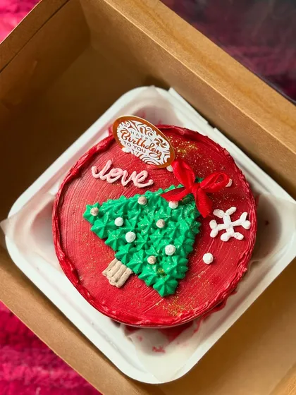 A festive Christmas bento cake with a buttercream tree and a snowflake. I make custom cakes for all seasonal celebrations.