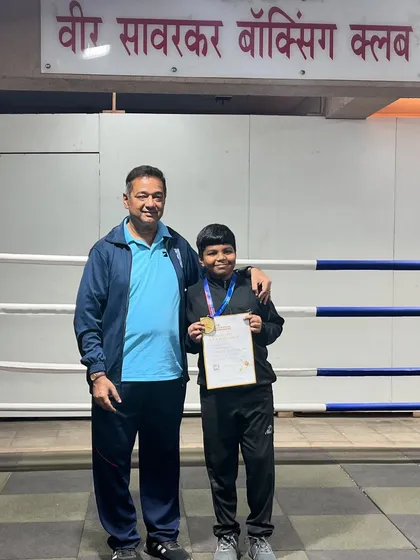 Standing with our SFA Boxing tournament gold medalist. This is the result of consistent training and dedication.