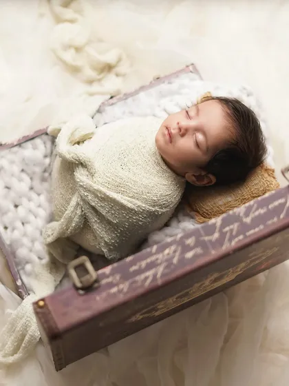 Another angle of the suitcase setup, with soft, dreamy fabric creating a cloud-like effect. I love playing with props to tell a unique story for each baby.