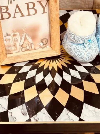 Even the smallest props matter. A pair of adorable baby booties placed next to a themed photo frame adds a personal and heartwarming touch.