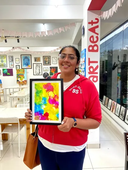 A participant with her vibrant alcohol ink painting. The way the colors blend and flow is what makes this medium so magical.
