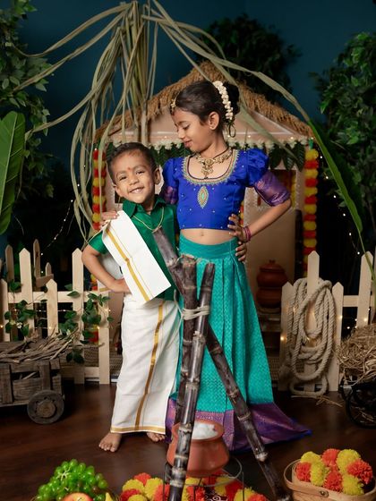 Celebrating the harvest festival of Pongal with a traditional and colorful setup, featuring siblings in beautiful South Indian attire.