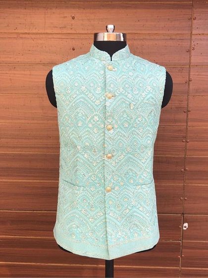 A light aqua Nehru jacket with a delicate white chikankari-style pattern. This piece is perfect for summer weddings and daytime events.