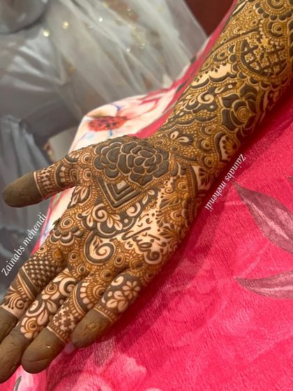 The palm side of Afnaz's Pakistani henna, featuring a large, bold floral motif.