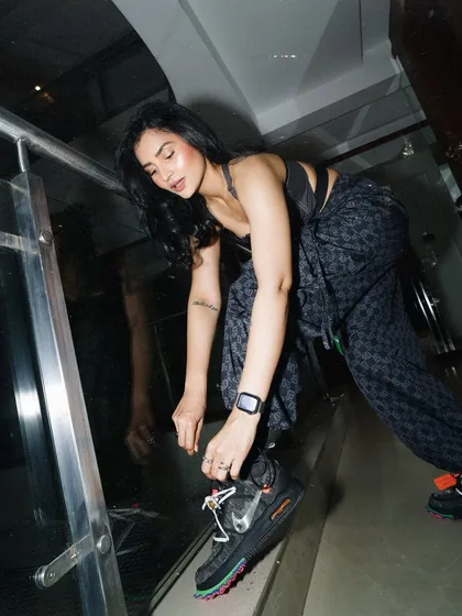 Lacing up my Off-White Nikes, a detail shot that shows how my love for fashion and sneakers is part of my DJ persona.