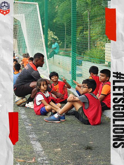 Learning on and off the ball. A coach sits with our youngest players, sharing knowledge and building a strong rapport with the team.