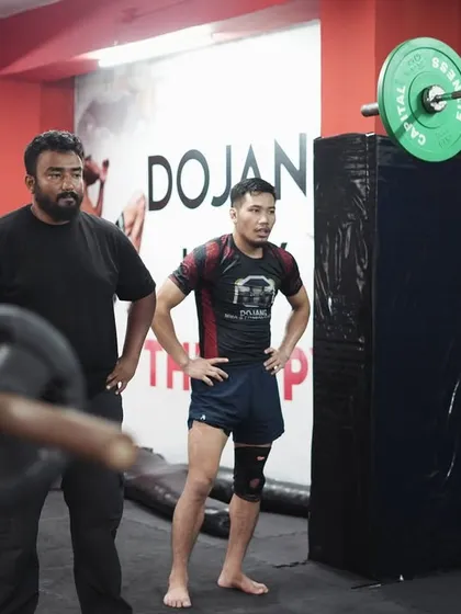 Proper form is everything. I'm always watching, ensuring every lift, like this overhead press, is executed safely and effectively to build real, functional strength. This hands-on coaching approach prevents injury and maximizes results.