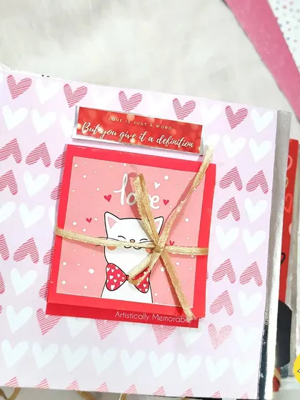 A cute page with a ribbon-tied note, part of a larger love-themed scrapbook.