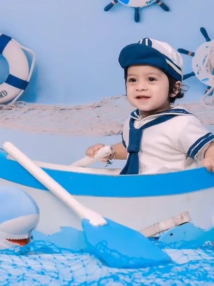 This little sailor is navigating the high seas with his shark companions.