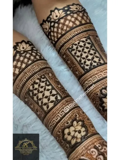 A detailed view of the forearm section of a bridesmaid's mehndi. You can see the clean lines of the geometric checks and the delicate floral work, all done with my organic henna.