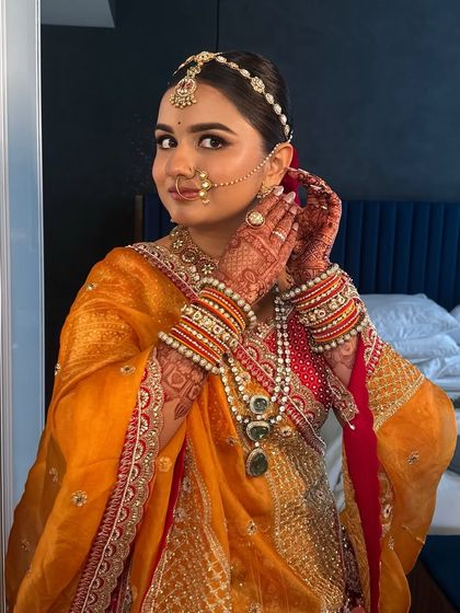 A candid getting-ready shot, adjusting her earring. These moments are just as beautiful as the final portraits.