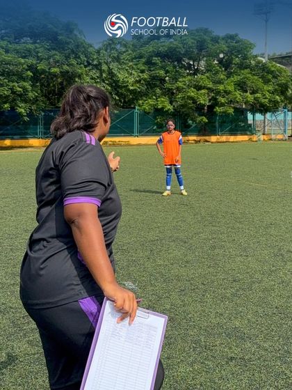 A coach with a clipboard observes players during trials, part of our structured process for identifying and nurturing new talent.