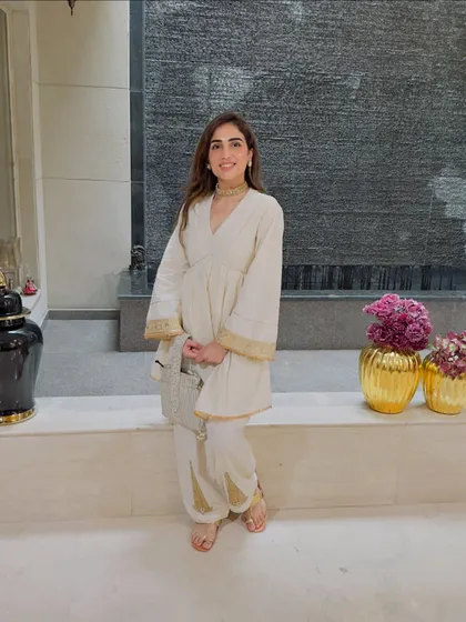 Posing by the water feature in my Rakhi outfit. This comfortable yet chic suit is perfect for a day of family celebrations.
