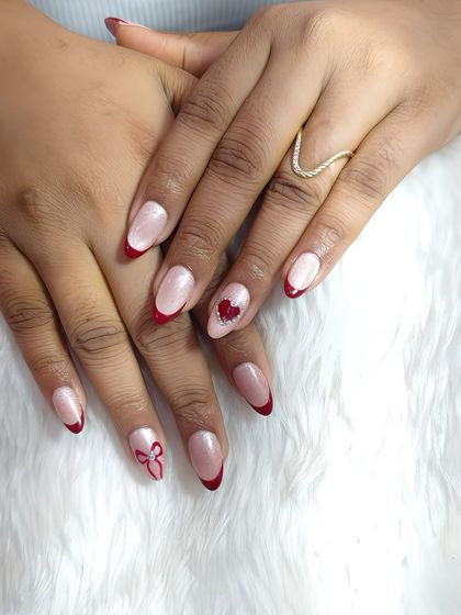 Red tips, tiny hearts, and a bow full of charm. This manicure screams soft glam with a flirty twist, perfect for Valentine's Day or any romantic occasion.
