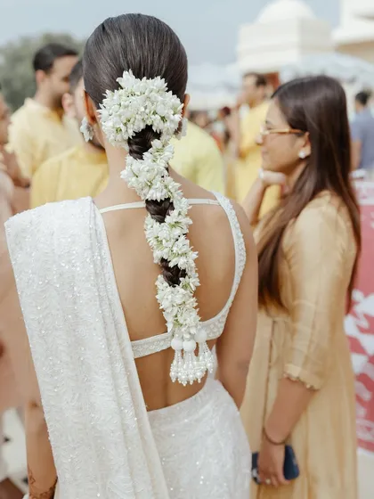 A beautiful hairstyle is the perfect finishing touch. Here, a traditional braid is elevated with a cascade of fresh gajra, a classic choice for a Haldi or wedding ceremony that adds fragrance and elegance.