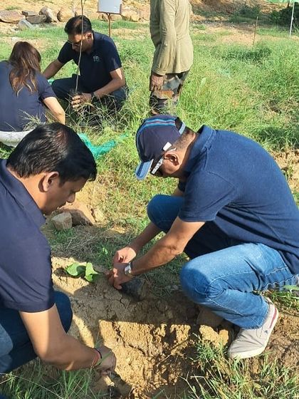 Volunteers from Bacardi work together to plant a sapling at Aravali Nagar Van. Their efforts are helping to reverse years of degradation from waste dumping and invasive species.