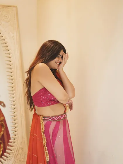 A candid, happy moment captured during a photoshoot. This shows that the best part of dressing up is feeling joyful and confident.