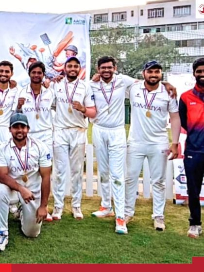 Another angle of the victorious K J Somaiya Institute of Management cricket team and their coach, celebrating a well-deserved championship win at the Lakshya 2026 tournament.