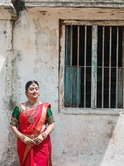 A wide shot that captures the rustic charm of an old temple wall, providing a textured and authentic backdrop for the bridal portrait.