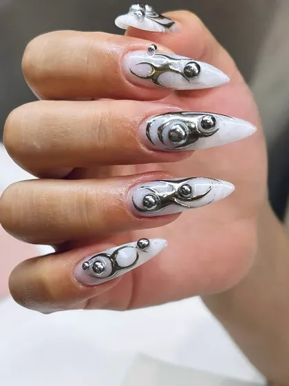 This is for the bold. We love pushing boundaries with avant-garde designs like this metallic and 3D sculpted set. If you want nails that are a true fashion statement, you've come to the right place.