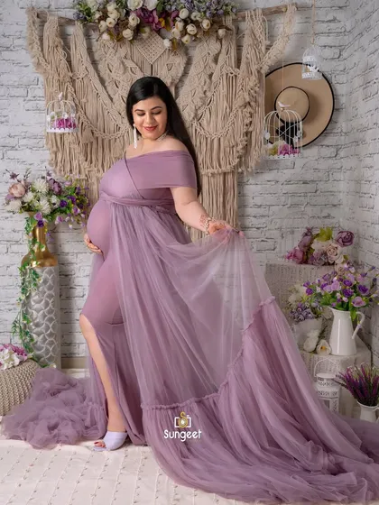 A graceful pose in a flowing lavender gown. The slit in the dress and the elegant drape of the fabric create a beautiful silhouette.
