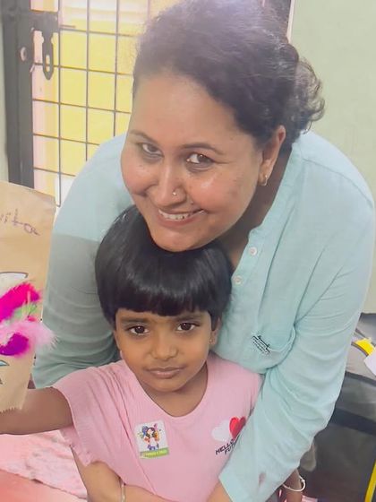A sweet moment with a young participant and her colorful rooster puppet. I love connecting with the kids and celebrating their artistic achievements.