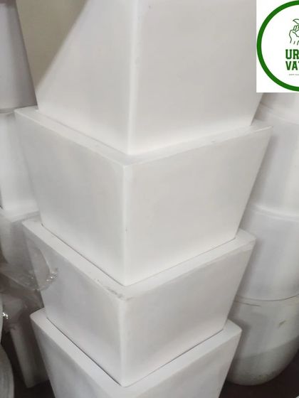 Stacks of white square plastic pots.